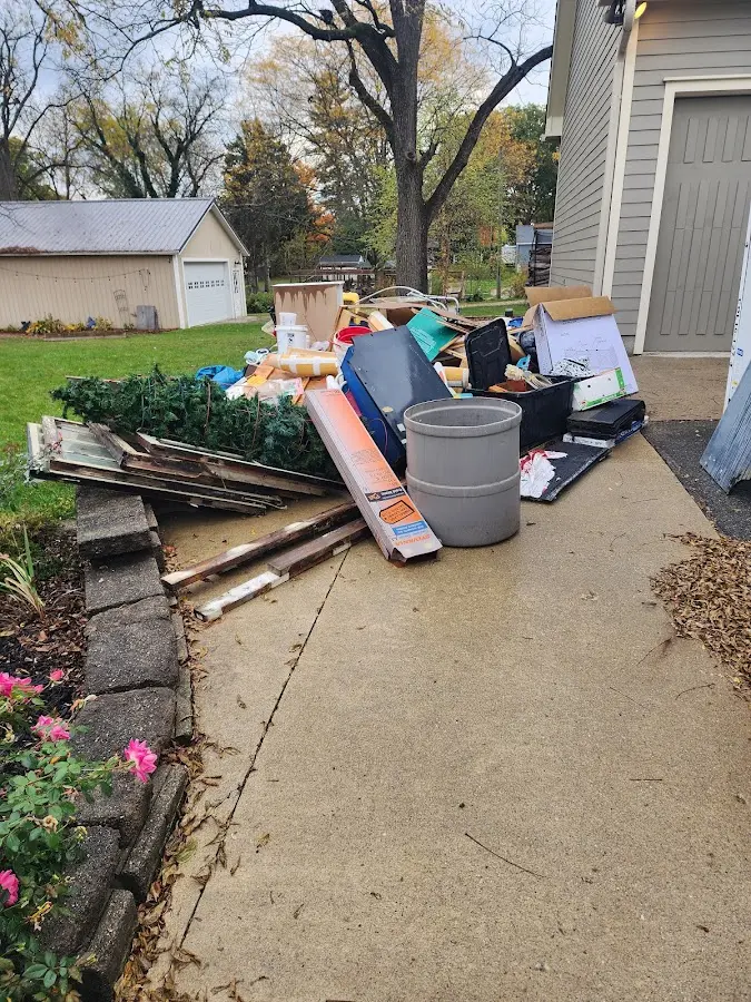 Dumpster being loaded with debris for Estate Cleanout Dumpster Rental in Lyndon